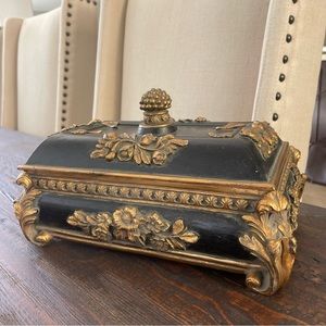 Vintage black decorative box with golden baroque ornaments.